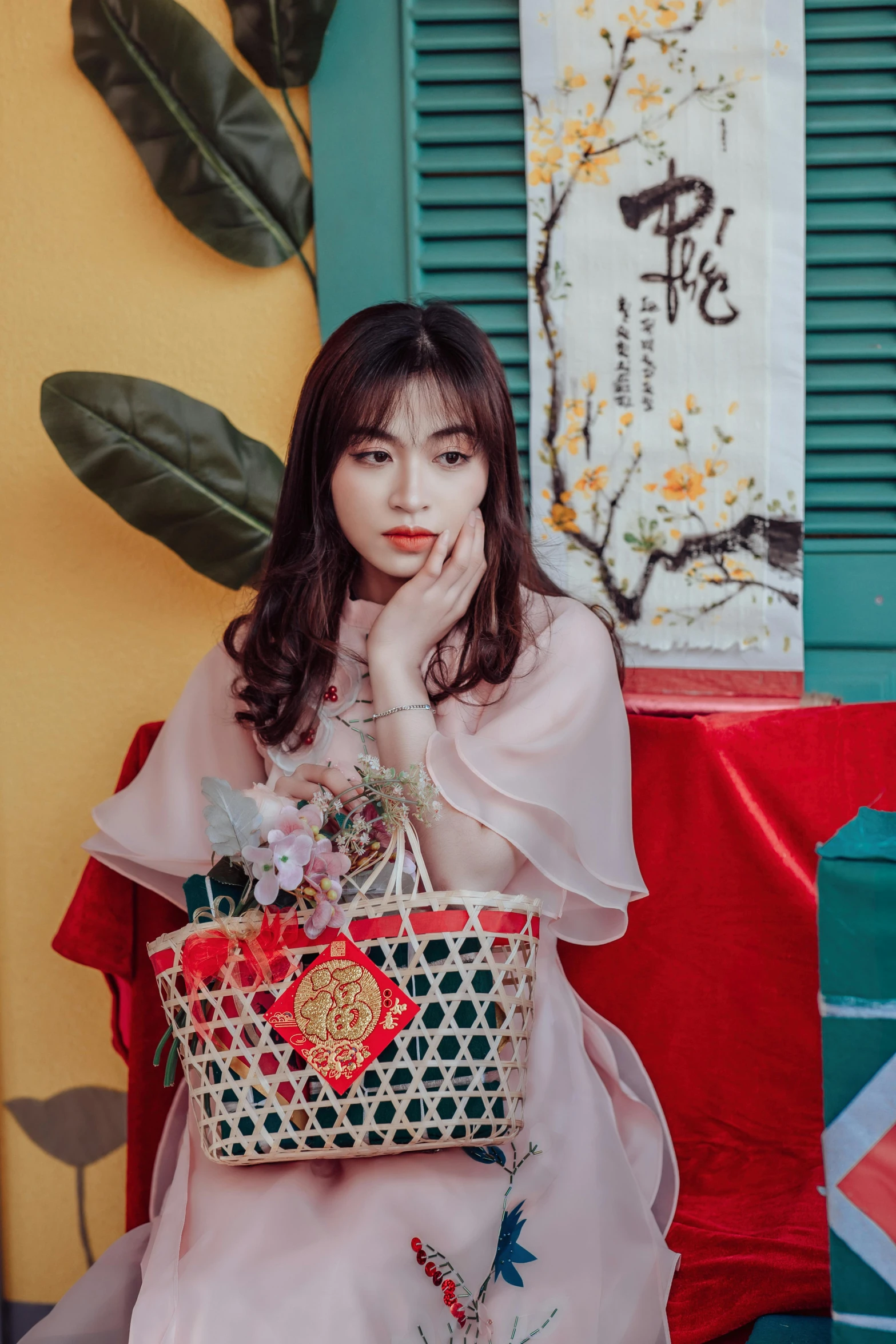 the woman is sitting on a red bench holding a basket