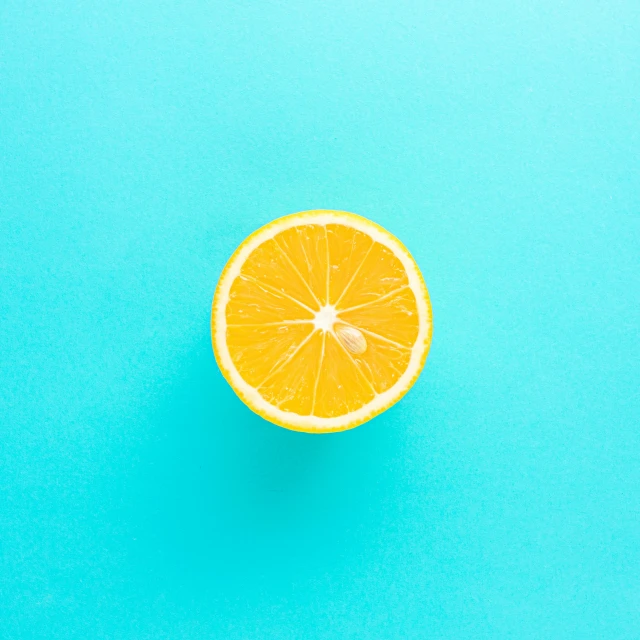 an orange is shown on a blue surface