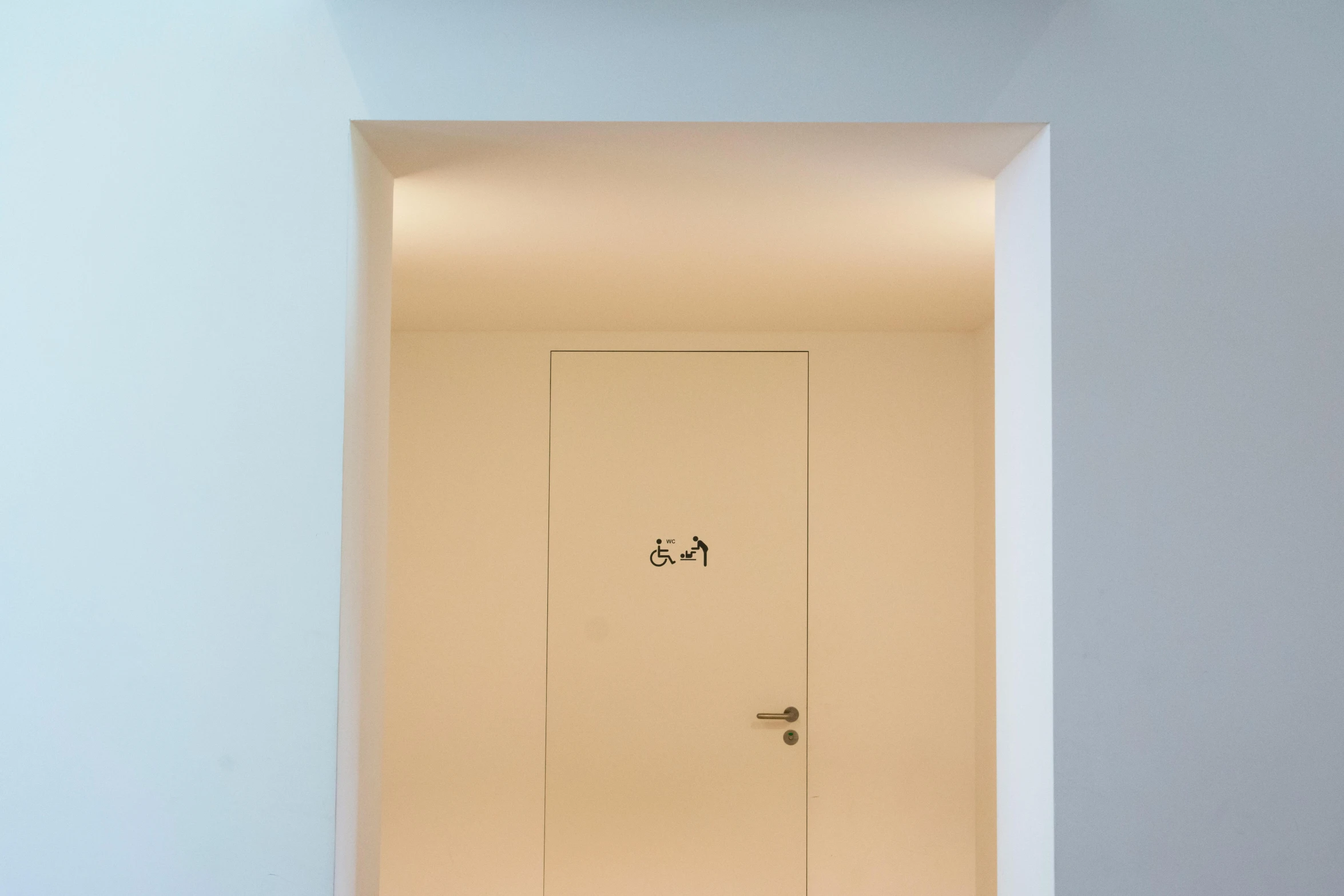 a tall door with a sign on it sitting in a hallway