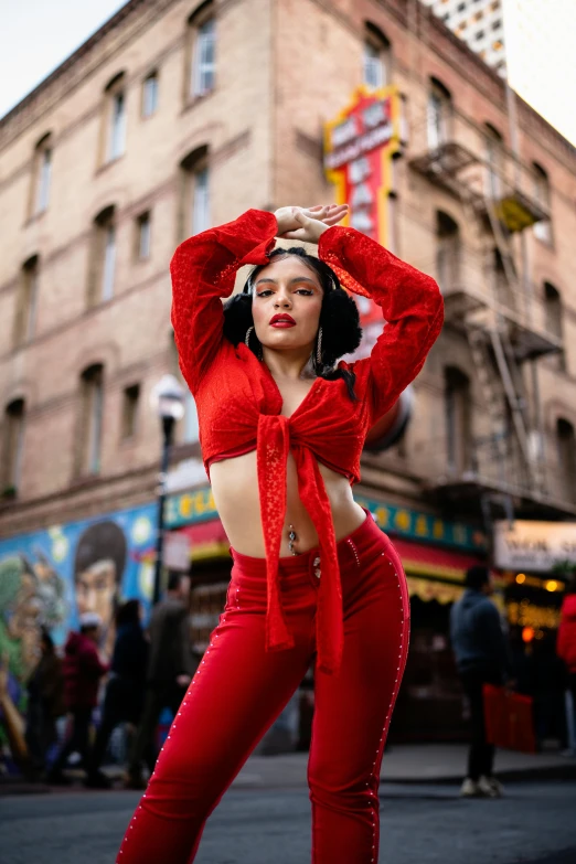 an image of woman doing the splits on street