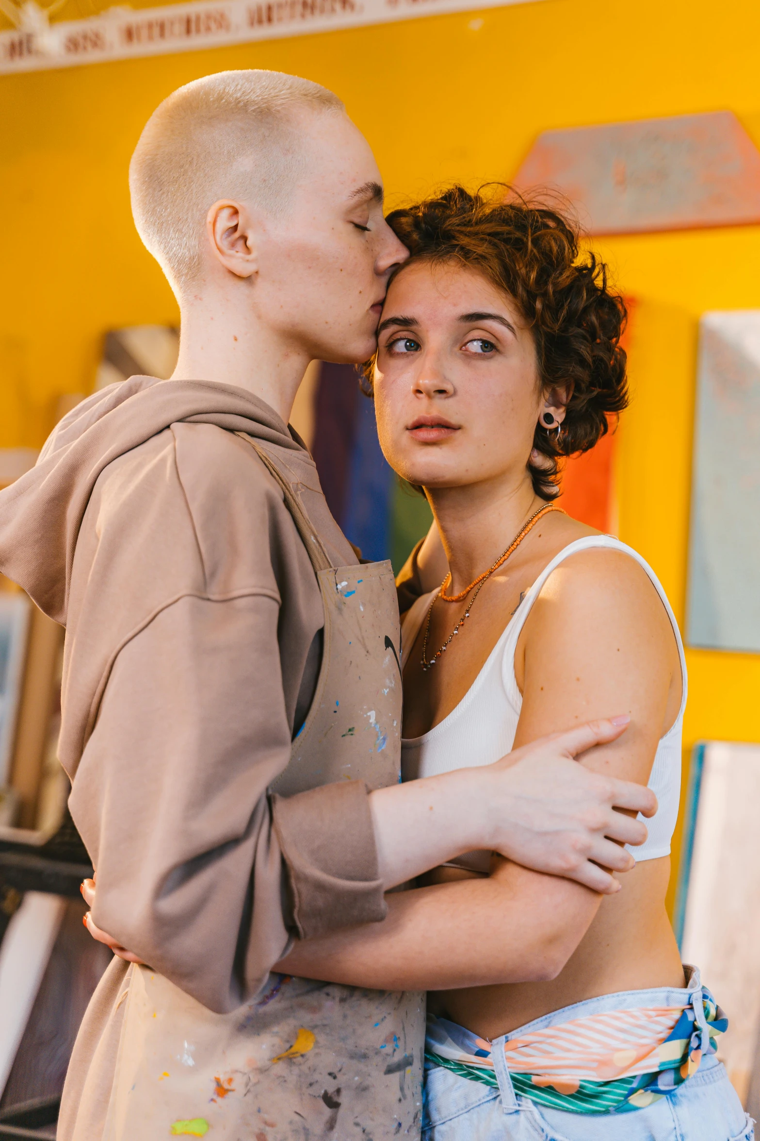 a man and a woman kissing in a room