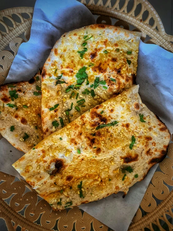 flat bread pieces sitting on top of a paper on a plate