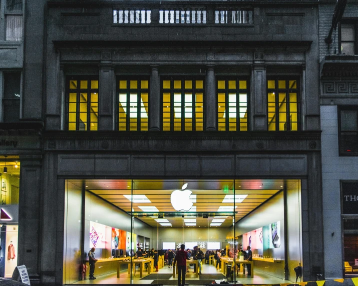 an apple store with its front lit up at night