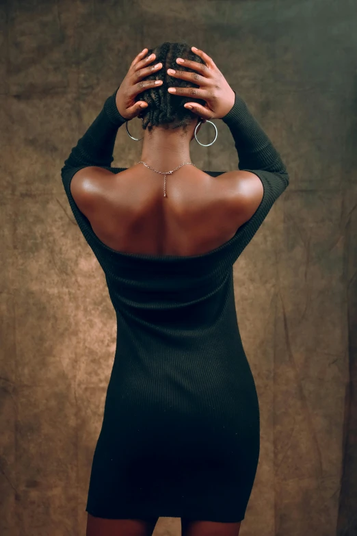 a woman in short black dress showing back view