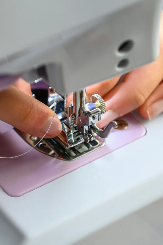 a person using a sewing machine on some material