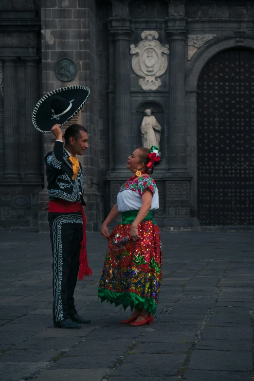 a man standing in front of a woman wearing a skirt