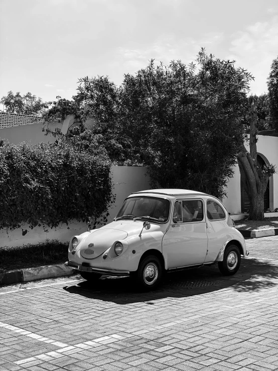 a small car is parked on a street curb