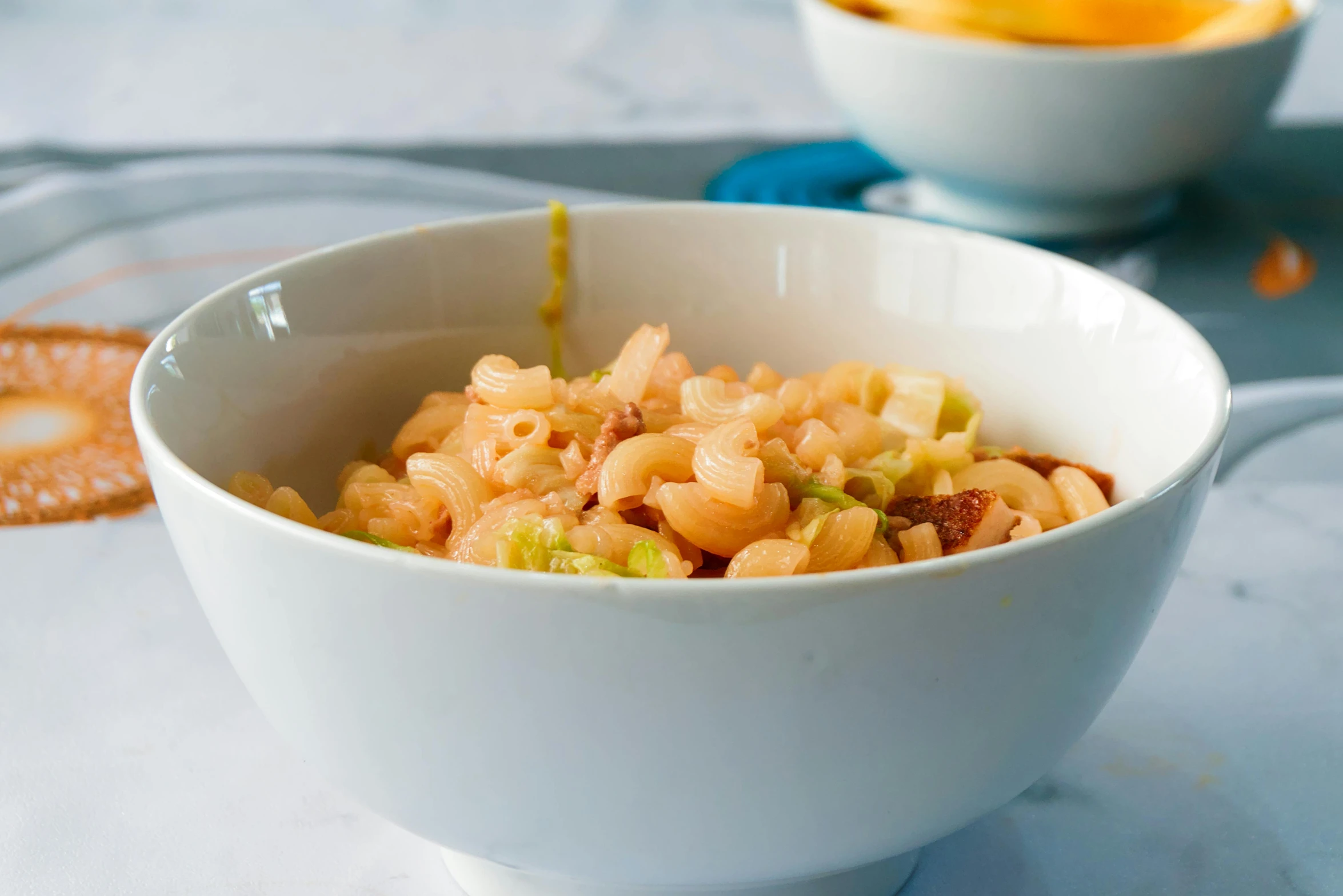 a bowl filled with pasta next to other foods