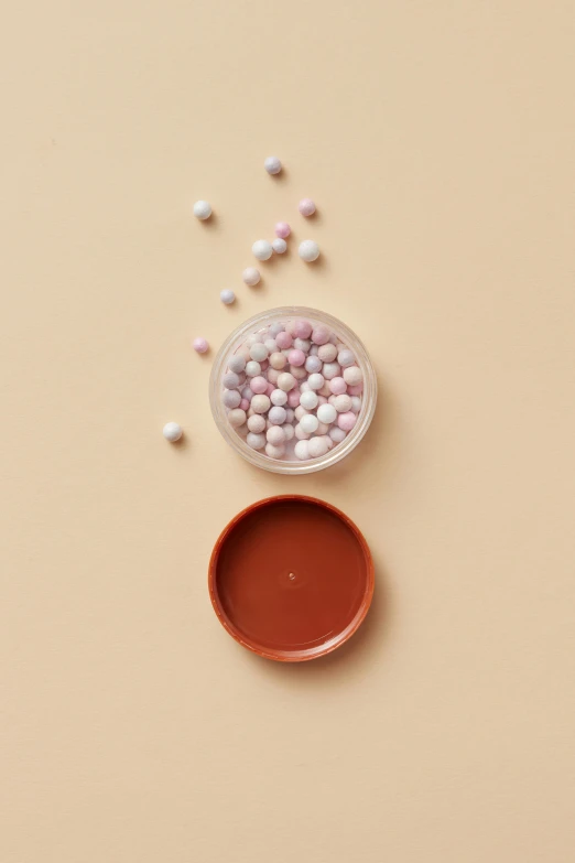 two red bowls with candies in them next to a container