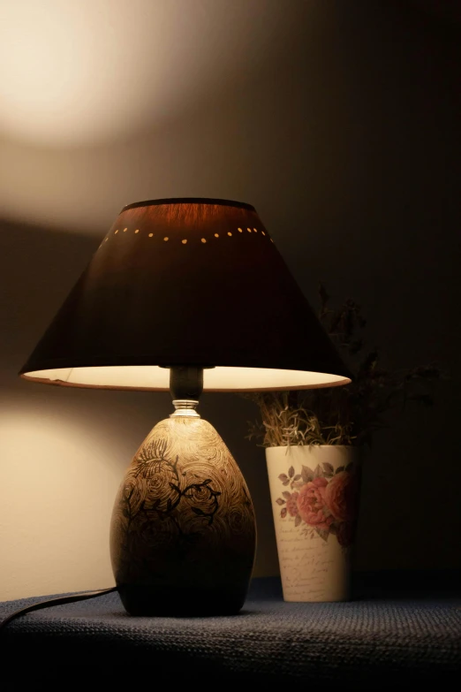 a lamp sitting next to a lamp on top of a bed