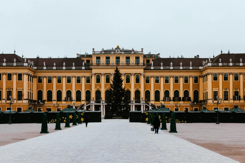 an old style palace is shown with a large christmas tree