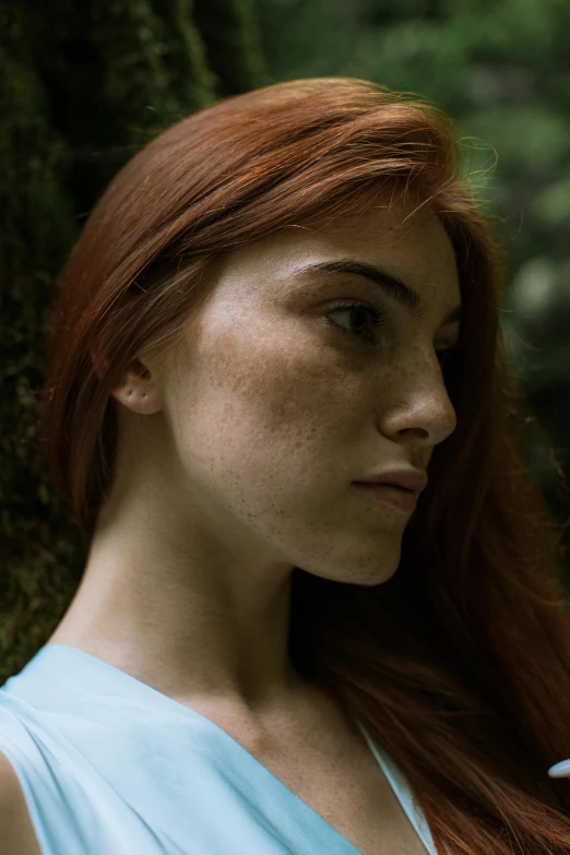 red haired girl with freckles and a shirt on