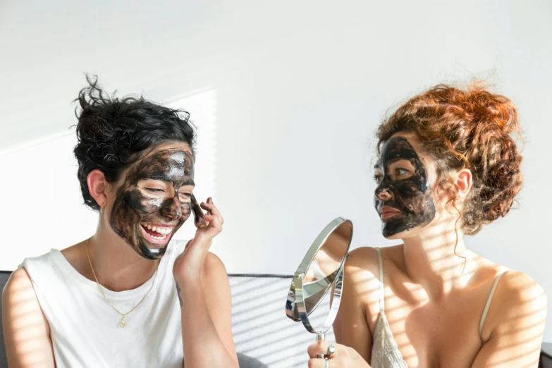 a man and woman with face paint on their faces