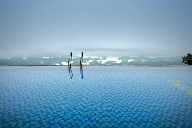 a pool with a few poles sticking out of the water