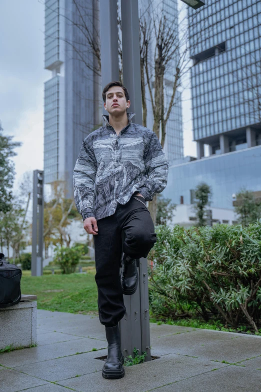 a man standing in front of a tall pole