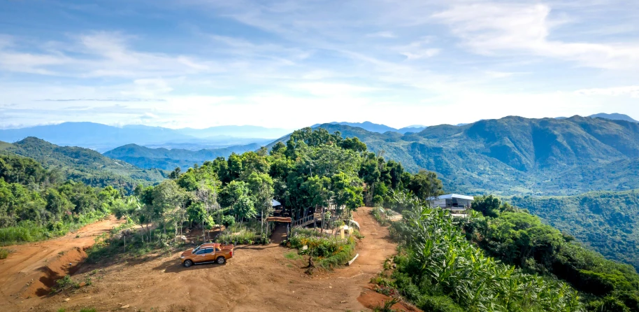 a scenic mountain landscape with a car in the middle