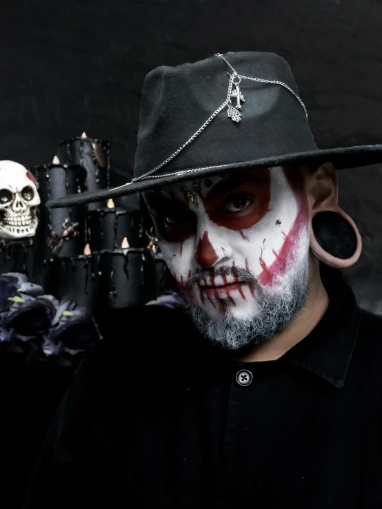 a skull man with makeup is posing for a po