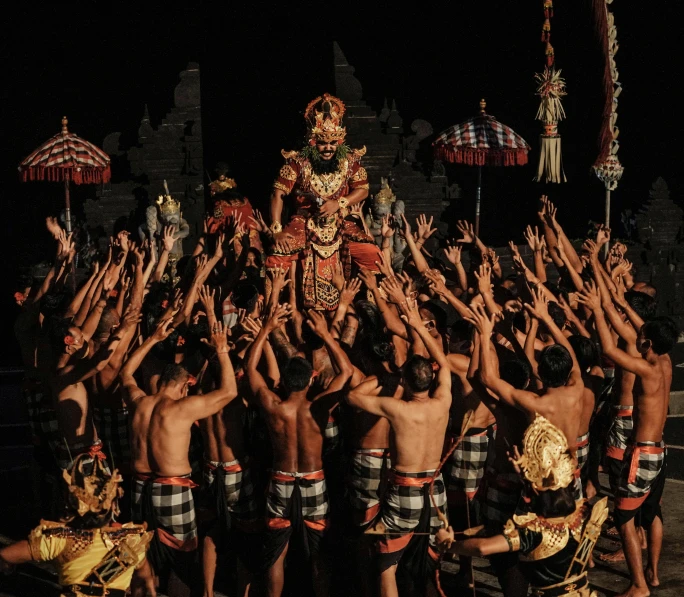 a number of people standing near one another with some umbrellas on the other