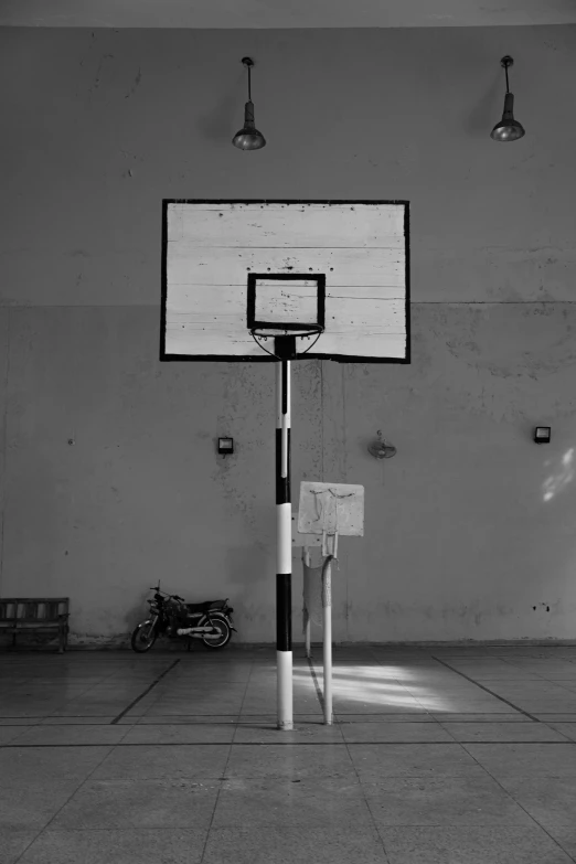 basketball hoop hanging off of wall with lights