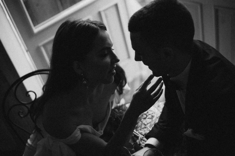 black and white pograph of young couple sitting together