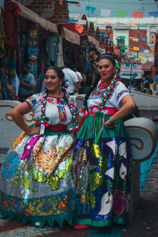 two young women wearing very colorful outfits standing outside