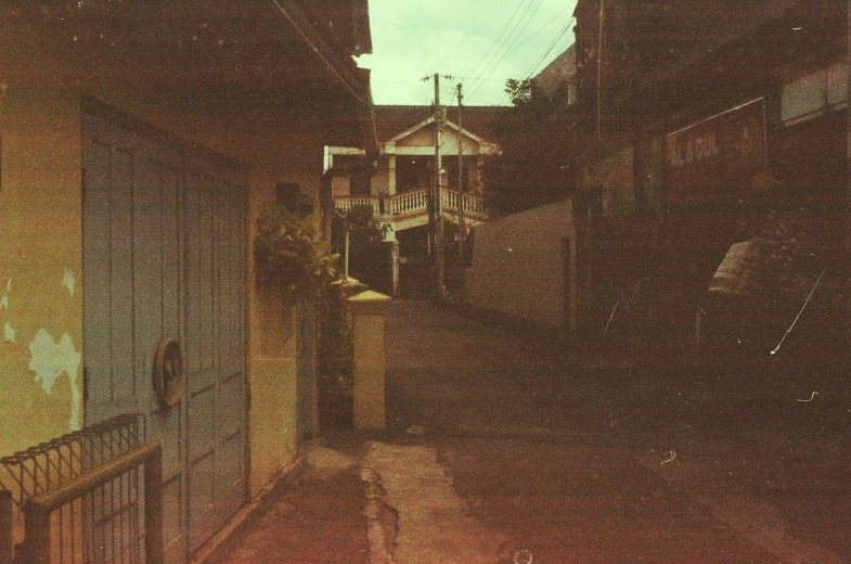 an old street with houses on both sides of the street