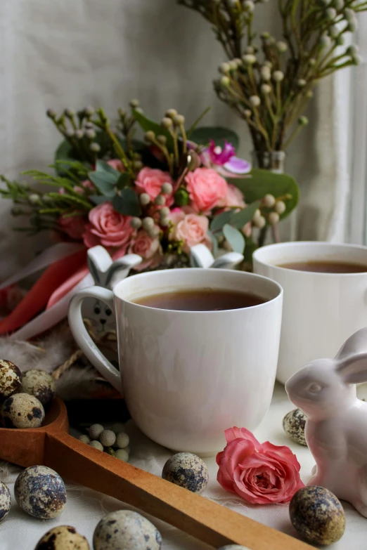 a mug with tea in it and some cookies in front