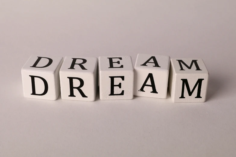 four block letters spelling dream, dream and dream