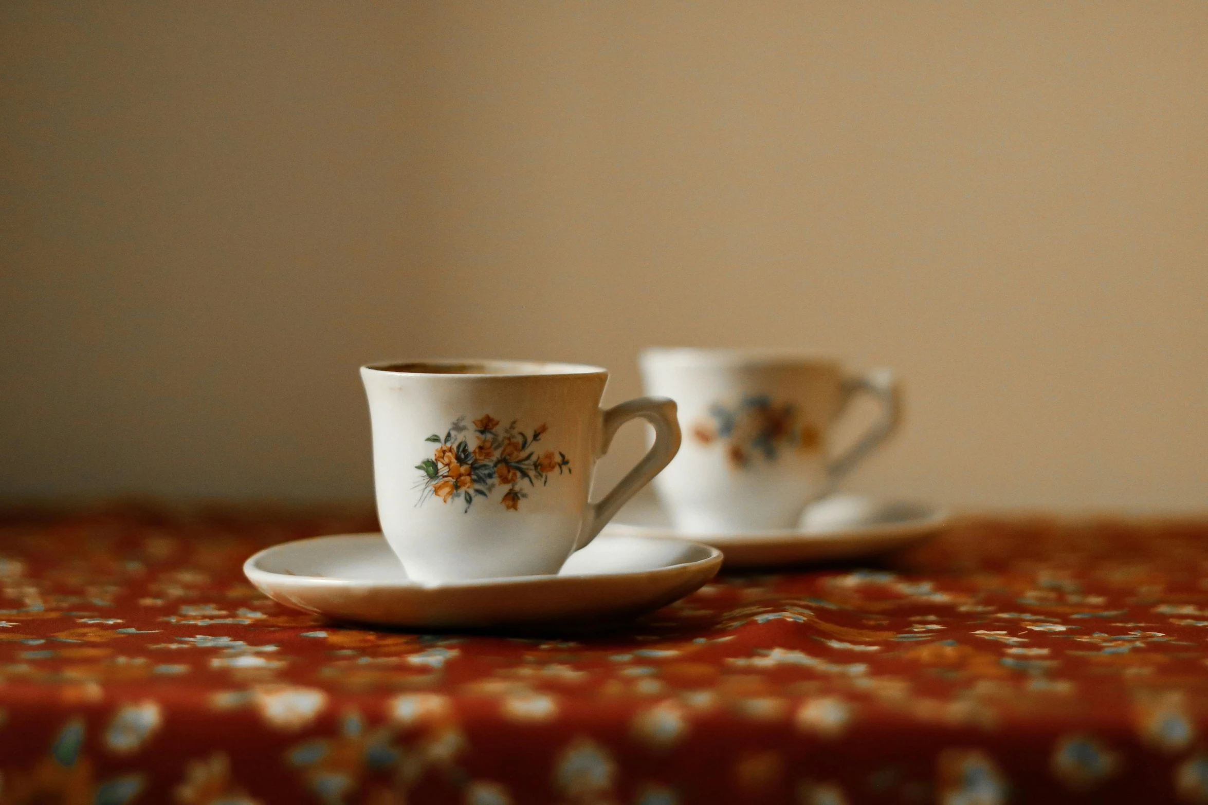 two coffee cups sitting on top of a table