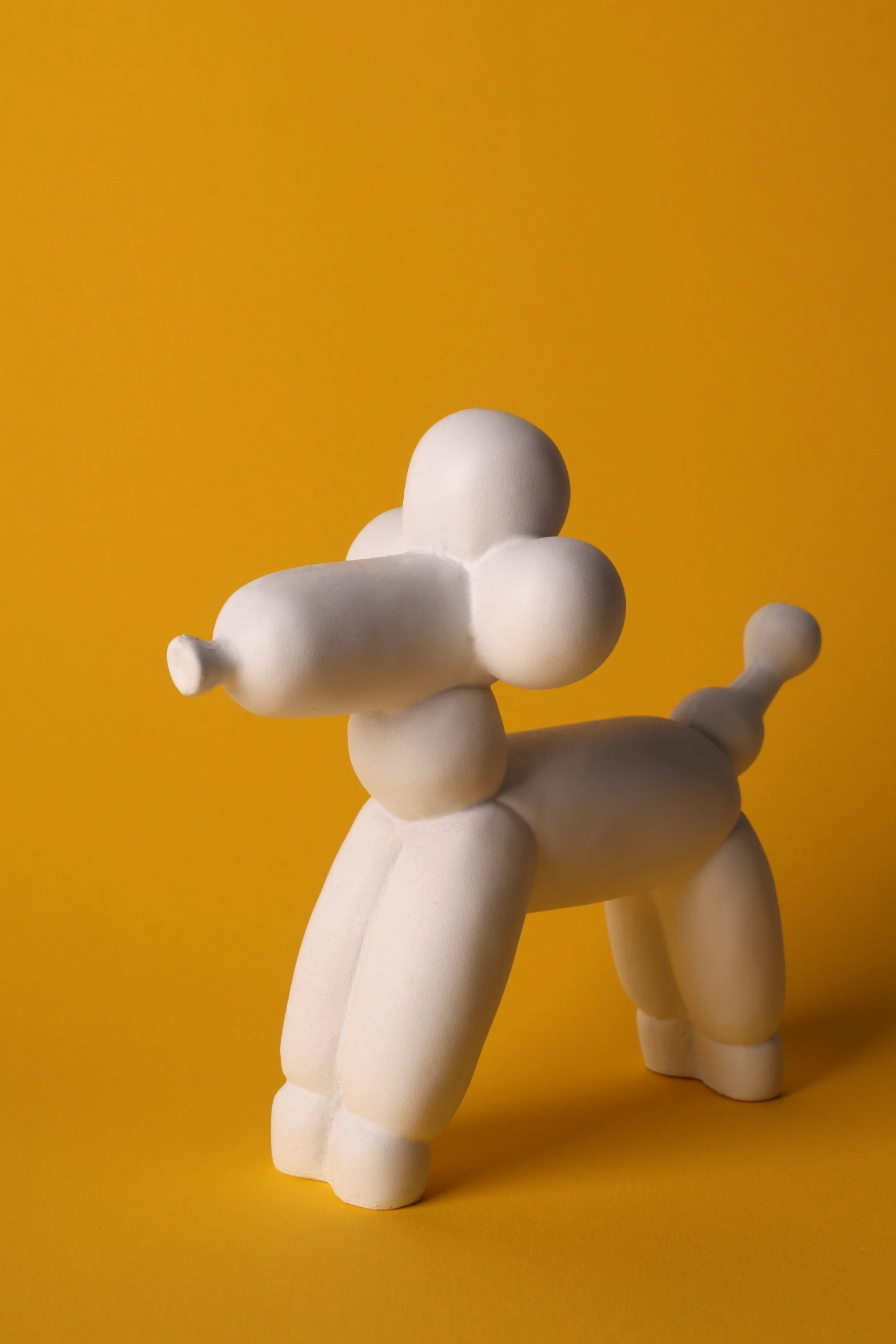 an edible toy dog standing in a yellow studio setting