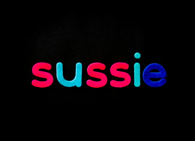 the word susse is brightly colored against a black background