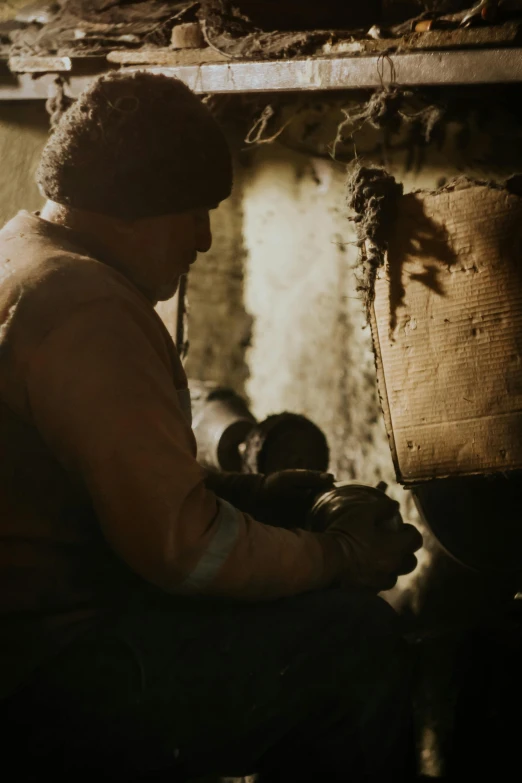 an older man works on a piece of wood