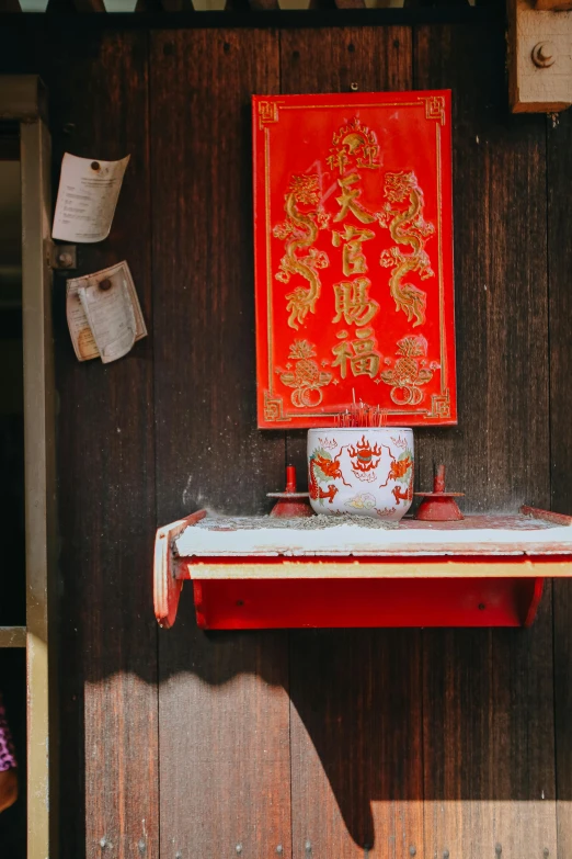 an asian design artwork over a red table