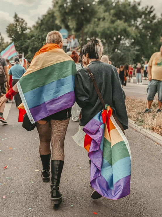 people walking down a road in a parade