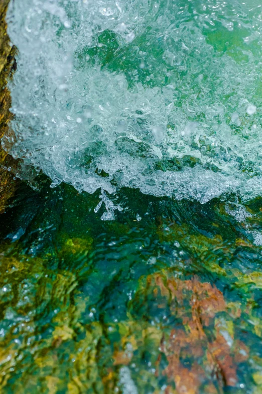 a person is standing over water with bubbles