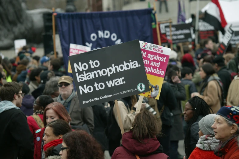 a group of people standing around with signs