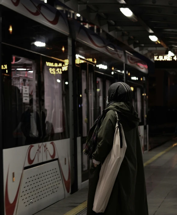 a person standing on a subway platform waiting for the train to come
