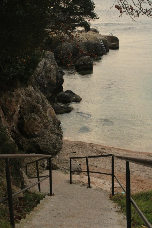 steps leading to a sandy beach by the ocean