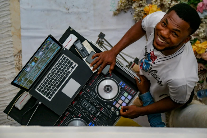 a smiling man displays his equipment for viewing