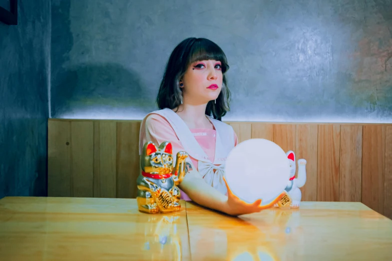 girl sitting at a table with her arm on the bowl