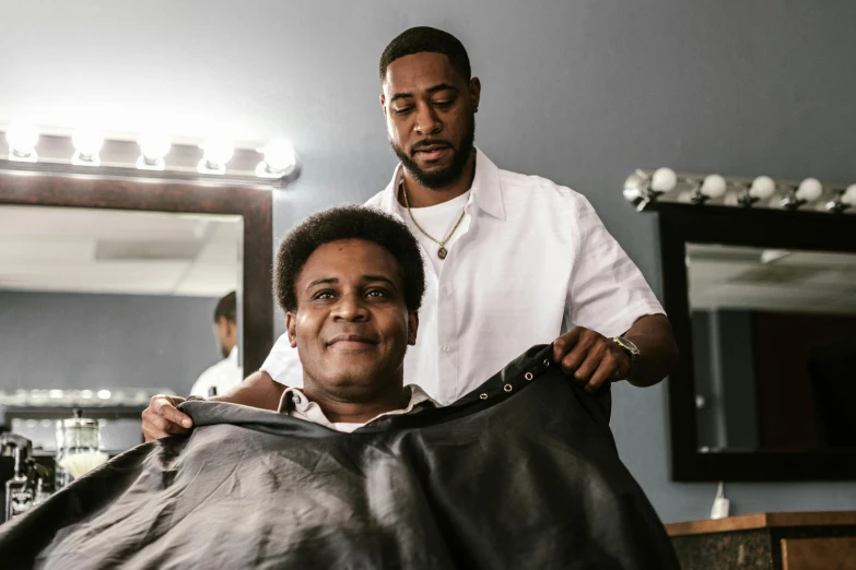 a man cuts another mans hair in the parlor