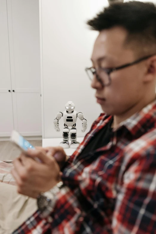 a man holding a cell phone while wearing glasses