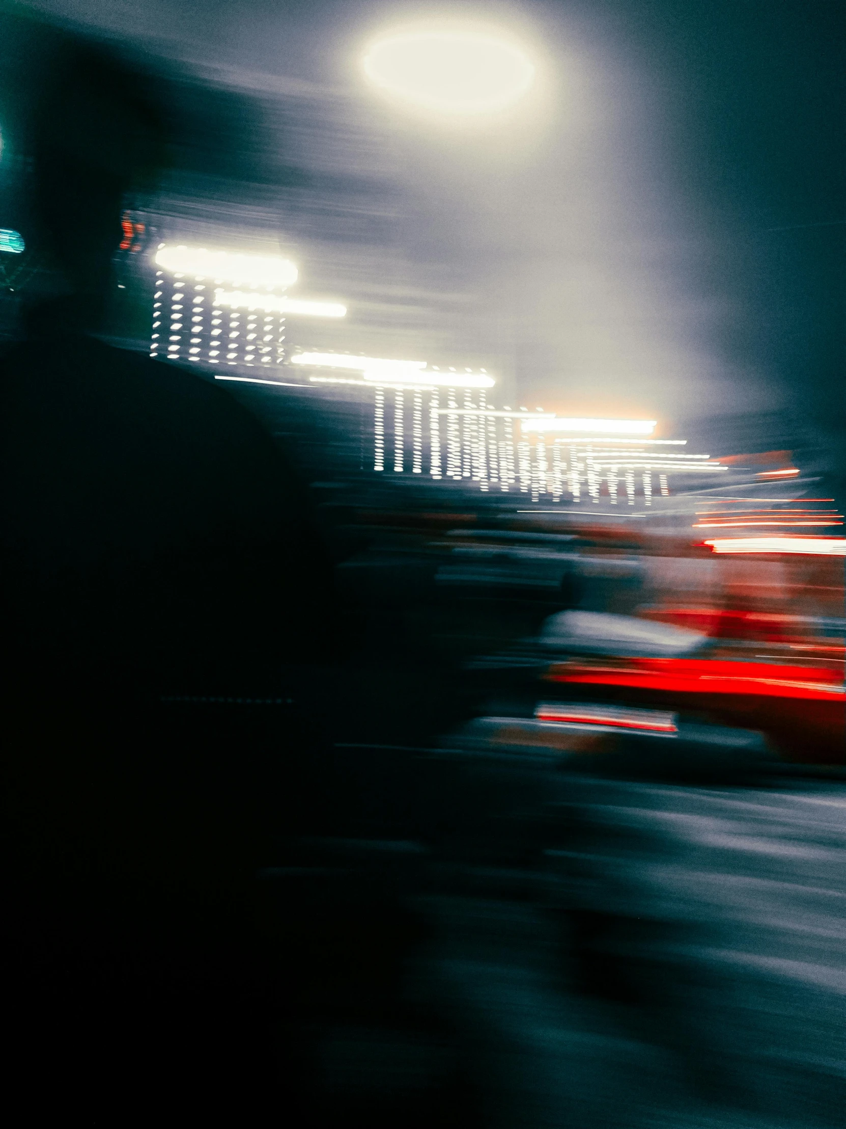 blurry picture of a highway at night with street lights