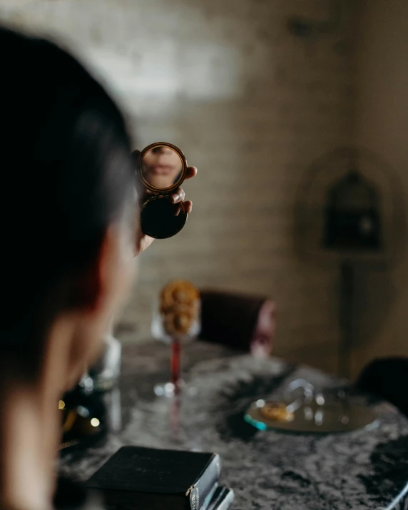 woman standing at a table with a plate and glasses on top