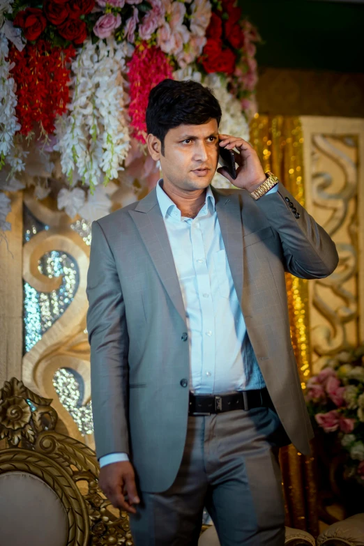 a man in suit standing and talking on the cell phone