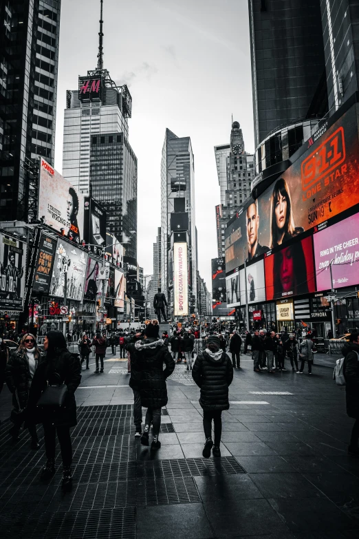 a black and white image of people on a city street