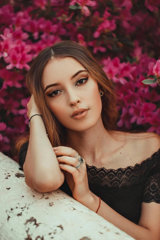 a woman posing for a po with flowers on the background