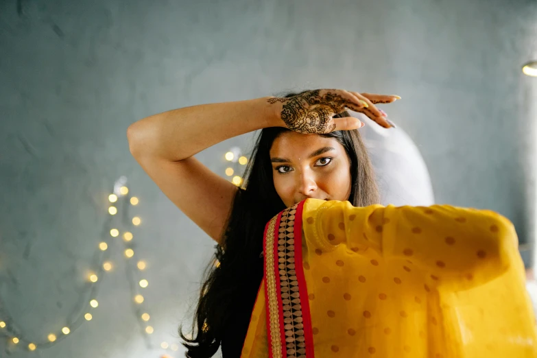 a woman holding her head behind her back