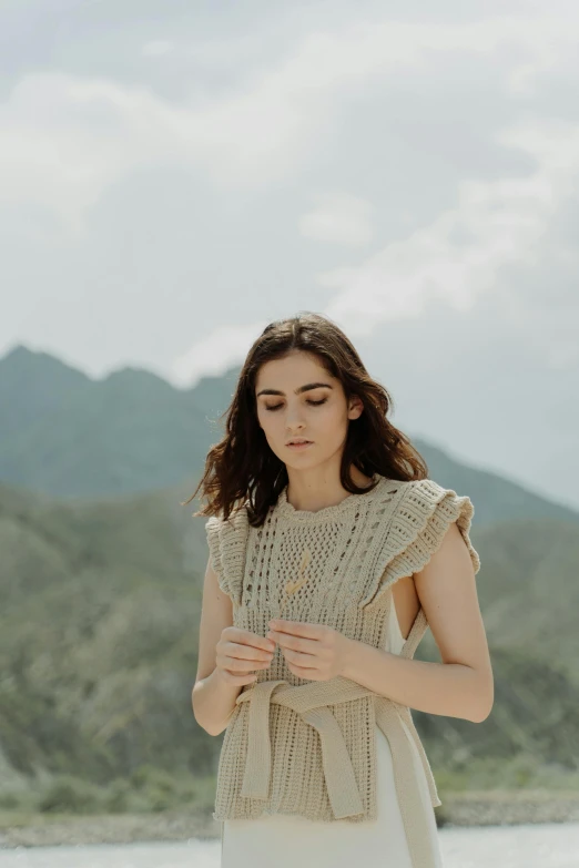 a woman wearing a knitted shirt and scarf