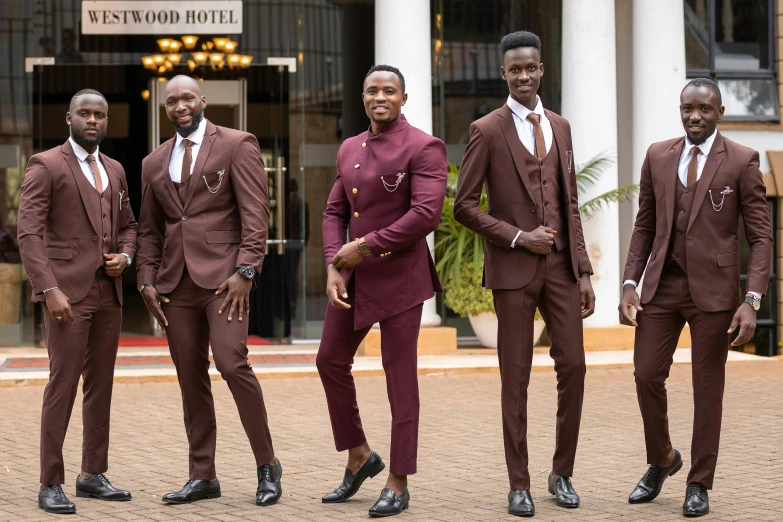 some men in red suits standing and smiling